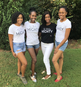 Four women gathered together wearing slim & mighty t-shirts in black and white